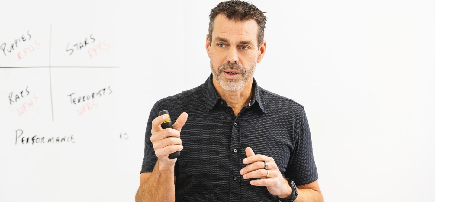 Jon Weening speaking to an audience during a presentation