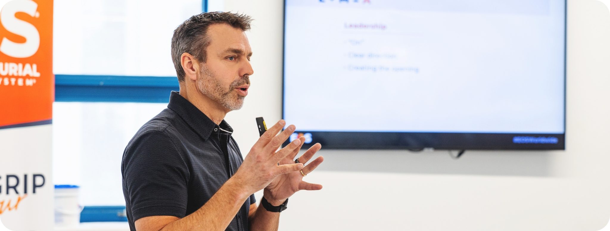Jon Weening speaking to an audience during a presentation